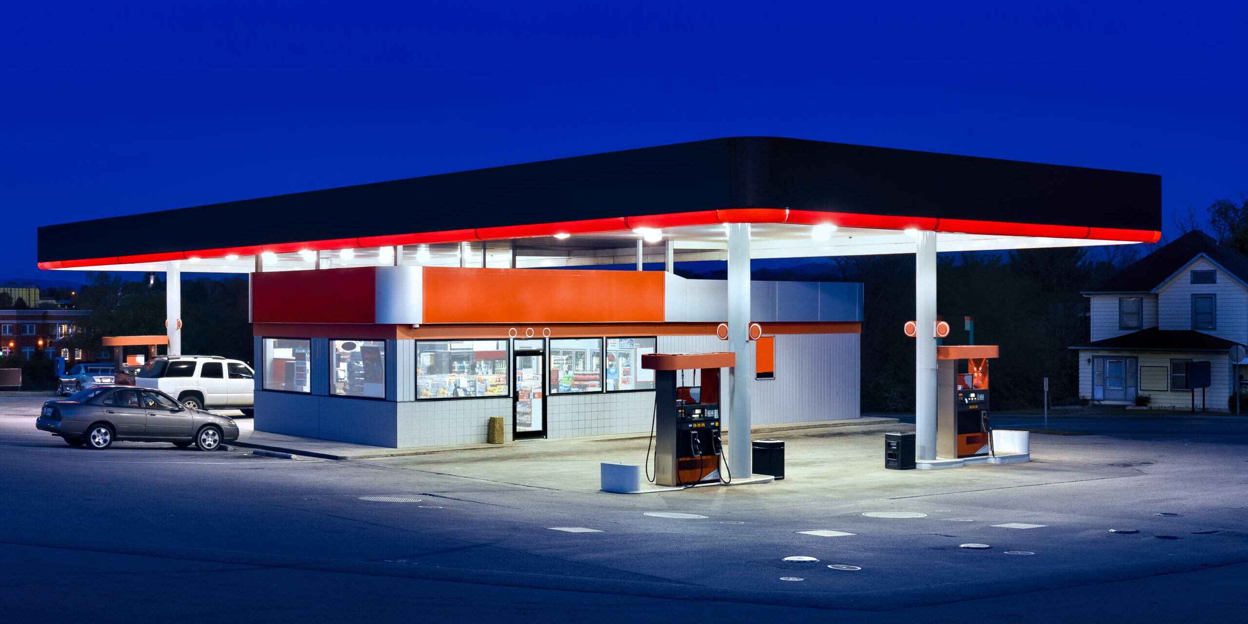 Horizontal shot of a generic gasoline station and convenience store at dusk.